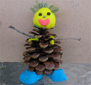 snowman from play dough and pine cone